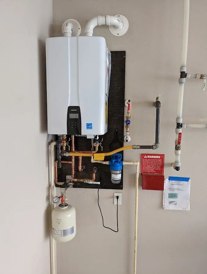 Professional plumber installing copper piping in a Littlefield home